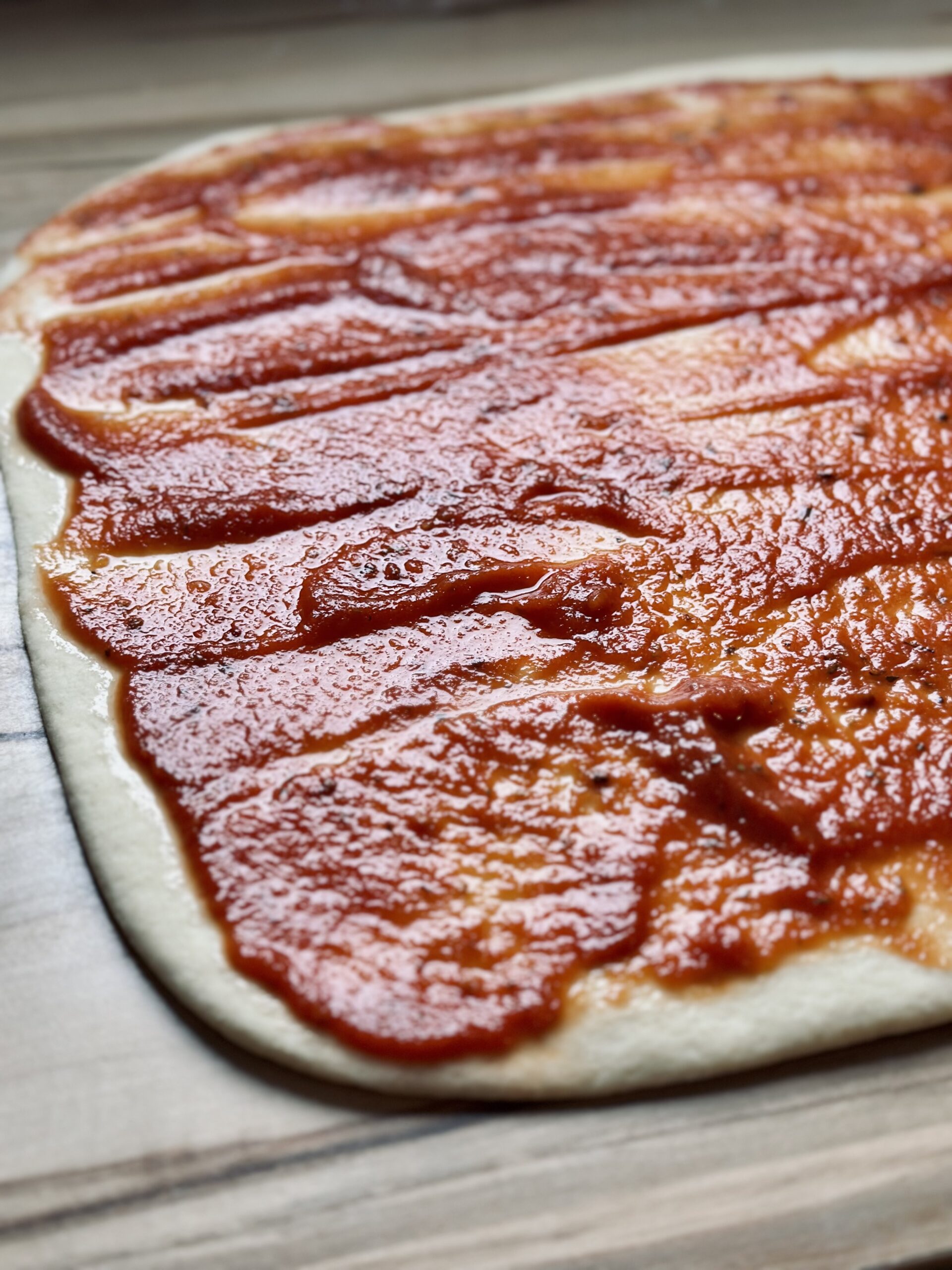 Pizzaschneckenteig mit Tomatensoße bestreichen