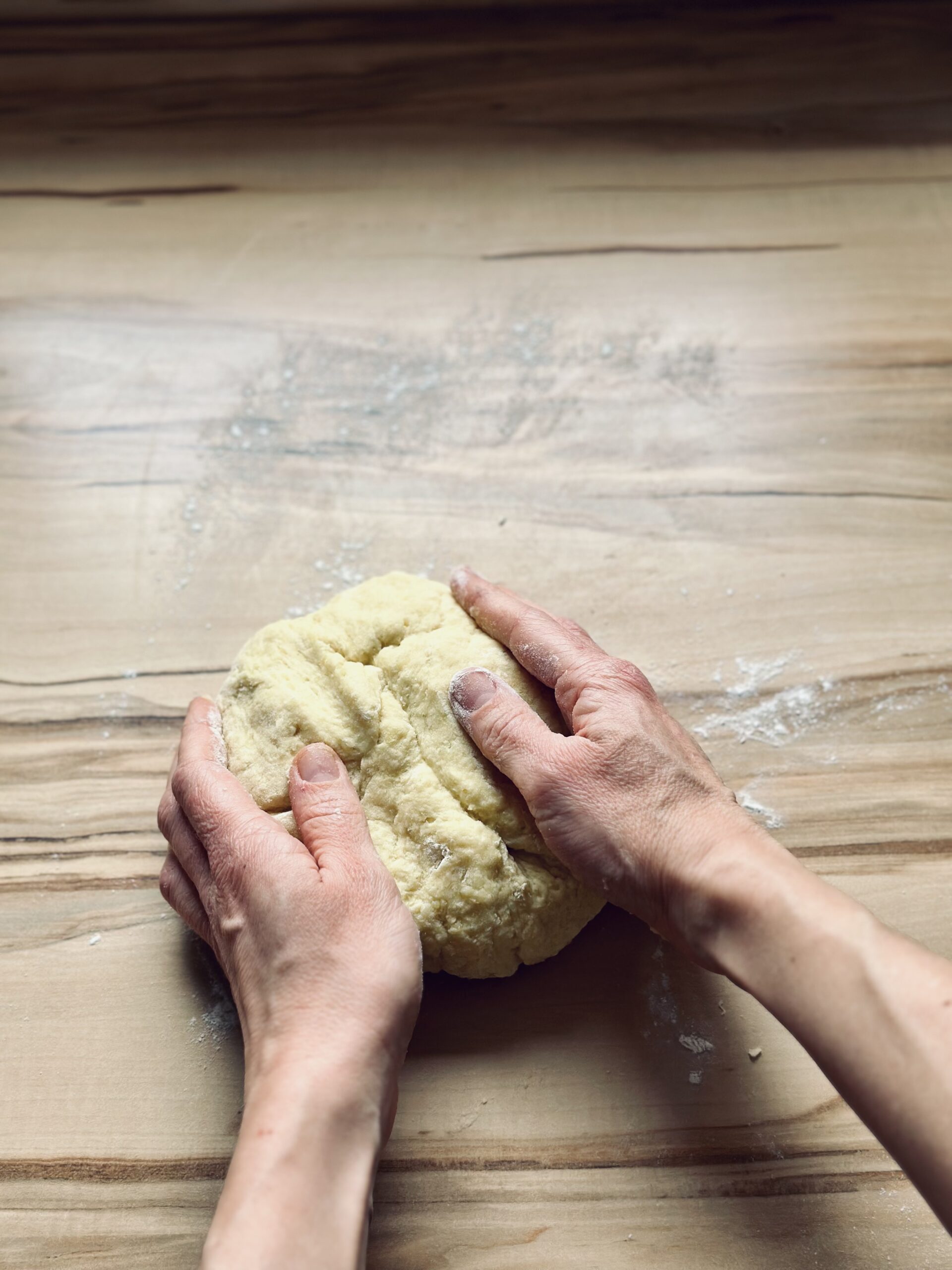 Teig auf einer Arbeitsfläche zu einer Kugel formen
